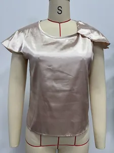 Close-up detail of champagne satin short sleeve blouse shown on a mannequin form