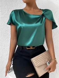 Detailed macro view of an elegant green satin blouse featuring a stylish shoulder twist knot.