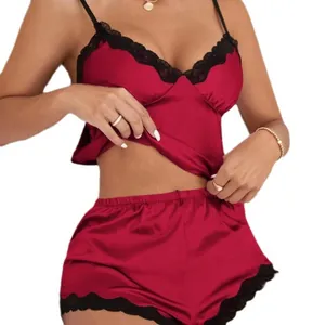 Elegant red satin two-piece sleepwear set featuring black lace trim and adjustable straps