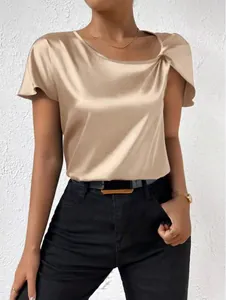 Detail of champagne satin short sleeve blouse with elegant shoulder twist