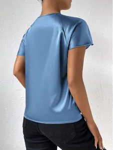 Detailed back view of a woman in a dusty blue satin short-sleeve top with silk texture