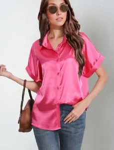 Detailed shot of a magenta short-sleeve satin button-up shirt for women's casual wear