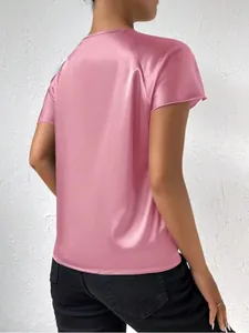 Back view of a pink satin short sleeve blouse showing smooth texture and loose fit.