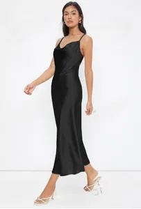 Full length detail of elegant black satin slip midi dress featuring a cowl neck design