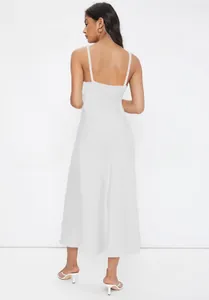 Back view of an elegant white satin slip dress with thin shoulder straps and a slim fit