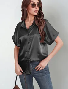 Detail view showing the elegant satin texture and button closure of the black shirt