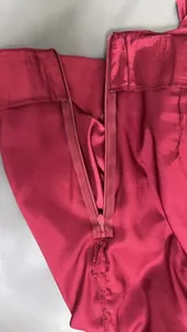 Close-up detail of a high-quality invisible zipper on a red satin mermaid skirt