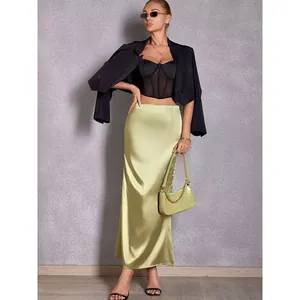 Full-length view of an elegant lime green satin fishtail skirt styled on a model