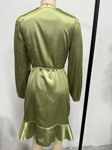 Detailed back view of an olive green satin long-sleeve midi dress with a ruffled hem