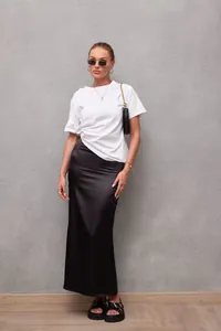 Elegant black satin midi skirt with glossy finish styled with white t-shirt for summer