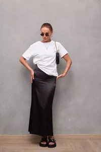 Full length view of elegant black satin mermaid maxi skirt with stylish white t-shirt