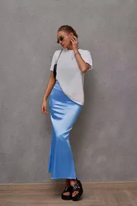 Elegant light blue satin fishtail skirt worn by a model in a minimalist setting.