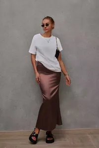 Brown satin fishtail maxi skirt paired with a white t-shirt for a chic summer look