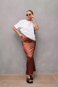Macro view of copper satin fishtail skirt showing smooth texture and elegant drape