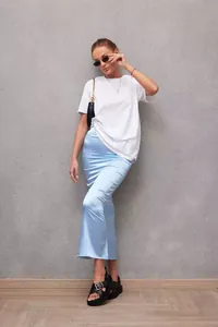 Detailed look of light blue satin fishtail midi skirt worn with white t-shirt
