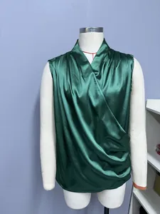Detailed view of the elegant dark green draped satin sleeveless wrap top for women