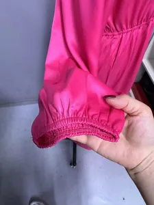 Detailed view of the elasticated lantern sleeve cuff on a fuchsia pink satin maxi dress