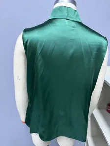 Detailed back view of a dark green satin sleeveless blouse displayed on a mannequin