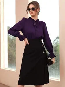Elegant purple satin long-sleeved shirt paired with a stylish black buttoned midi skirt