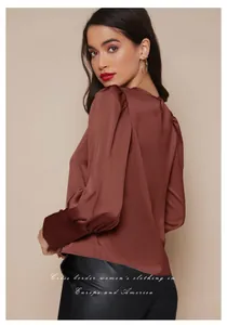 Vista detallada de una elegante blusa de satén granate para mujer con mangas farol modernas