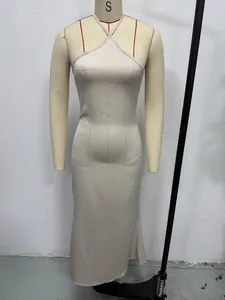 Detailed macro shot of a sleek champagne satin halter neck evening gown on mannequin stand