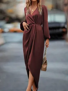 Elegant burgundy satin maxi dress featuring lantern sleeves and a wrap-style slit detail.