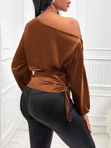Detailed view of copper satin blouse featuring off-shoulder neck and side drawstring detail.