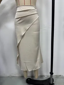 Close-up detail of a cream-colored satin midi skirt featuring a wrap front design and silky texture