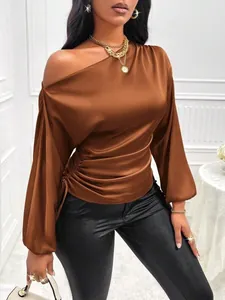 Detail of elegant copper satin blouse with asymmetrical neckline and long sleeves