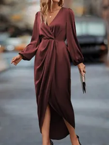 Detail of elegant burgundy satin maxi dress with lantern sleeves and V-neckline