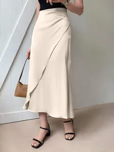 Elegant cream satin midi skirt featuring a wrap-style drape and smooth finish.