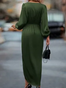 Elegant back view of dark green satin maxi dress with lantern sleeves and sexy slit