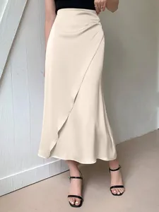 Elegant cream satin midi skirt featuring a sophisticated side wrap and smooth silky texture