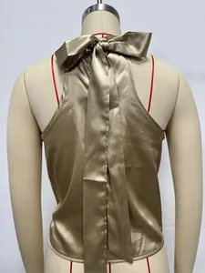 Back view of champagne satin halter top with large decorative bow detail on mannequin