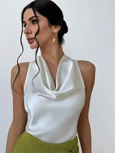 Close-up of elegant sleeveless white satin blouse featuring a draped cowl neck design