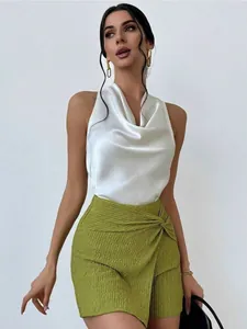 Elegant white satin sleeveless cowl neck blouse worn by a model for a stylish summer look.