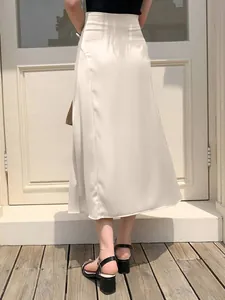 Detailed back view of a champagne satin midi skirt featuring an elegant high waist design
