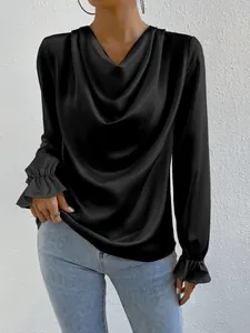 Detail view of a black satin long sleeve blouse with a draped cowl neck and ruffle cuffs.