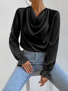 Detail view of a black satin long sleeve blouse with a stylish cowl neck and ruffled cuffs.