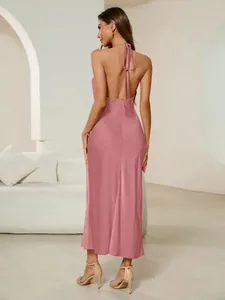 Back view of an elegant dusty rose satin maxi dress with a halter backless design.