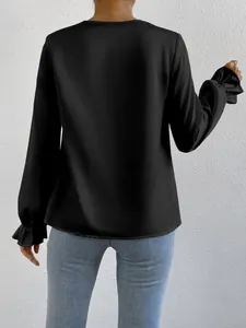 Elegant black satin long sleeve blouse featuring ruffled cuffs shown from the back