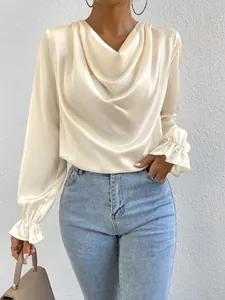 Detailed view of champagne satin blouse with elegant cowl neck and ruffled cuffs