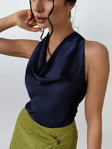 Detail of a navy blue satin sleeveless halter top featuring a sophisticated cowl neck design.