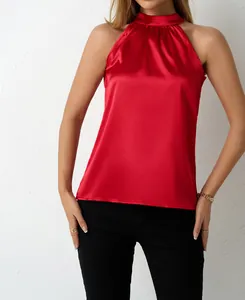 Detail view of red satin halter neck top with smooth silk-like texture and elegant drape