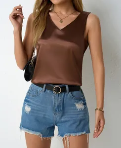 Elegant chocolate brown satin V-neck tank top styled with distressed denim shorts and belt