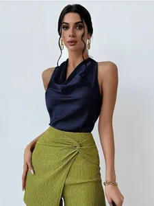 Detail view of navy blue satin sleeveless blouse with cowl neck and textured skirt