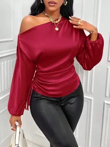 Elegant wine red satin blouse featuring an asymmetrical off-the-shoulder neckline and lantern sleeves