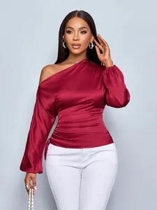 Detailed view of an elegant wine red asymmetric satin blouse with one-shoulder design
