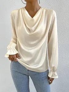Elegant champagne satin blouse detail featuring cowl neck design and ruffle cuffs