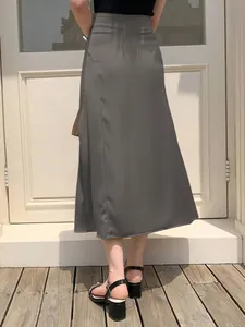 Detailed back view of an elegant grey satin midi skirt with a smooth silky drape